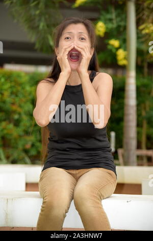 An Asian Woman Shouting Stock Photo