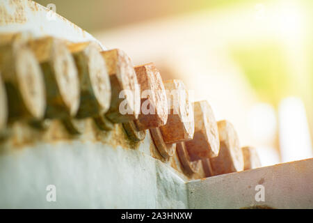 Big rusty metal nuts locked with rust and corrosion bolts Stock Photo