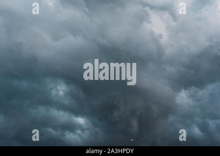 Looking up at dark, stormy looking clouds in the sky. Stock Photo