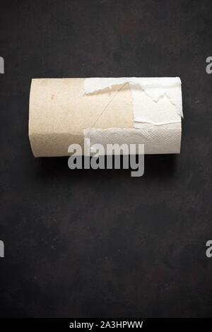 Empty toilet paper roll on a black table Stock Photo