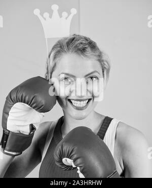 Fight for success. VIP gym. Fighting queen. Woman boxing glove and crown symbol of princess. Queen of sport. Become best in boxing sport. Feminine tender blonde with queen crown wear boxing gloves. Stock Photo