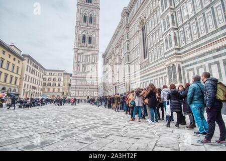 FLORENCE, ITALY - 17 FEBRUARY 2018: Numerous tourists from all over the world visit the city center full of monuments and statues Stock Photo