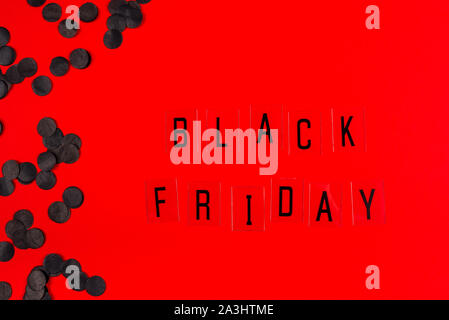 Black Friday sale tag on red background. Stock Photo