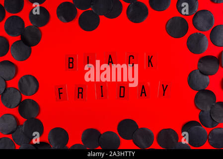 Black Friday sale tag on red background. Stock Photo