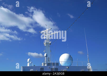 Satellite navigation system and radar on board a ship protected by a radome or golf ball Stock Photo