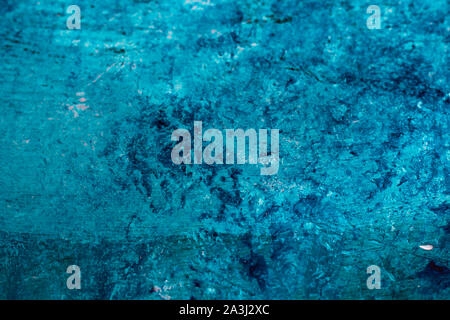 Abstract rough textured concrete wall pained with blue and mint green acrylic paint Stock Photo