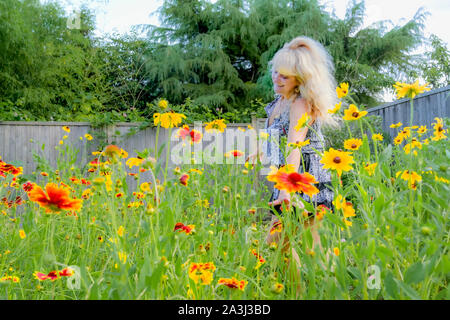 Woman dancing in wildflowers Stock Photo