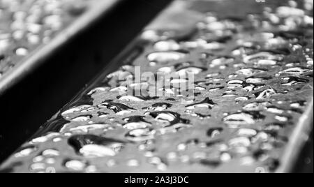 water drops on bench monochrome photo. Beautiful picture, background, wallpaper Stock Photo