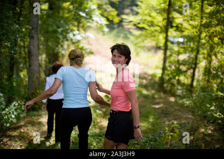 Middle aged women walking in forest Stock Photo
