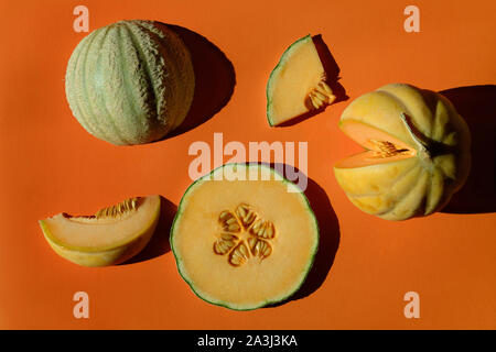 Slices cantaloupe sliced isolated on orange background. Flat lay Stock Photo