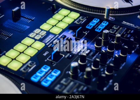 DJ mixing deck and turntables at night with controls for mixing music for a party or disco Stock Photo