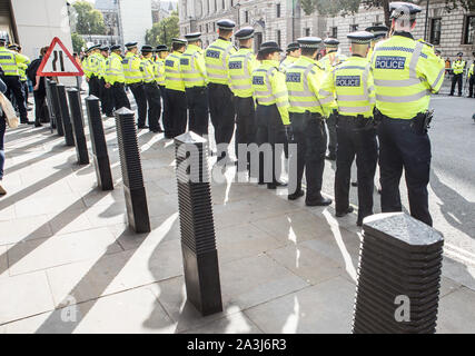 London, UK. 08th Oct, 2019. Police on guard during the environmental protest by Extinction Rebellion activist group.Extinction Rebellion is an international movement that uses non-violent civil disobedience in an attempt to halt mass extinction and minimise the risk of social collapse. The group has blocked a number of key junctions in central London. Credit: SOPA Images Limited/Alamy Live News Stock Photo