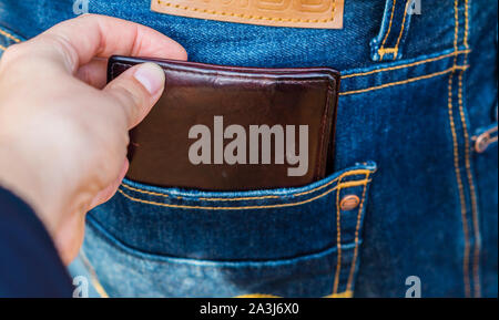 Stealing a purse from a trouser pocket Stock Photo