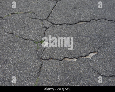 cracked black tarmac texture useful as a background Stock Photo