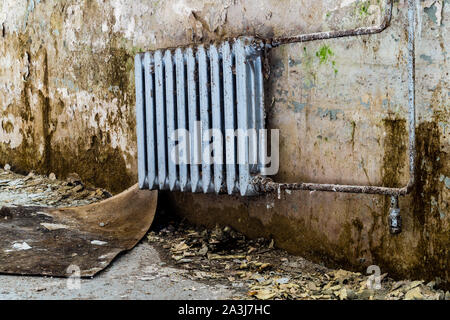 Old heating after water damage in the room Stock Photo