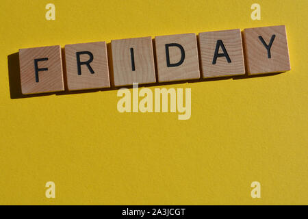 Friday in 3d wooden alphabet letters on a bright yellow background with copy space Stock Photo