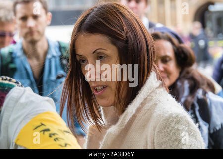 London, UK. 8th October 2019. Liberal Democrat MP for Brecon and Radnorshire Jane Dodds collects an English Oak. Campaigners bring 1000 native trees in pots to Old Palace Yard with labelled for MPs, world leaders and others, inviting MPs to come and collect their tree. The symbolic action called on the government and MPs to plant billions of trees across the UK, and support the planting of trillions more around the world. Credit: Peter Marshall/Alamy Live News Stock Photo