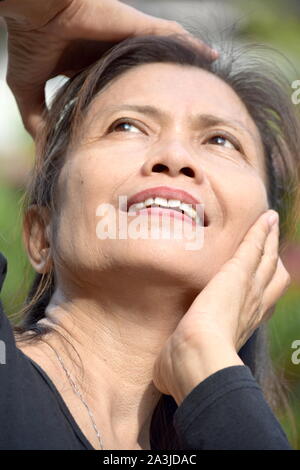 A Female Senior Wondering Stock Photo