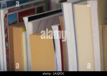 Image of books of different sizes viewed from the side so that they are not identified Stock Photo