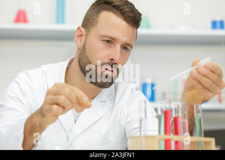 two scientists doing experiments with chemical liquid in the lab Stock Photo