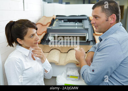 woman chooses a ceramic tile in a store Stock Photo