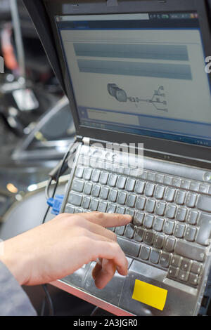 using laptop for vehicle diagnostic Stock Photo