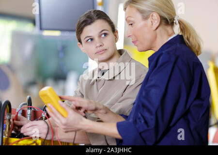 portrait of two female engineers in workshop Stock Photo