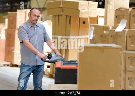porter carrying boxes in a warehouse Stock Photo