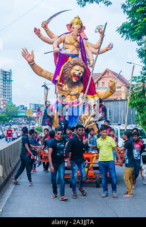 Indian men carring Ganesh idol during Ganesh Chaturthi festival in Mumbai India Stock Photo