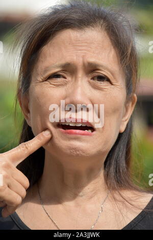 Older Asian Female Senior With Toothache Stock Photo