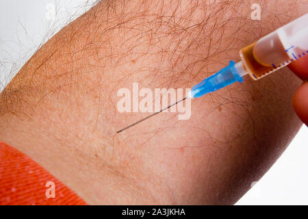 Drug addiction, male using drugs in syringe Stock Photo