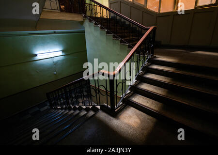 Stairs with wooden trail and illuminated by little sunlight Stock Photo