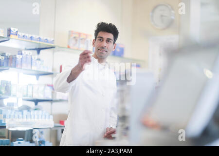 pharmacist in a pharmacy with a tablet Stock Photo