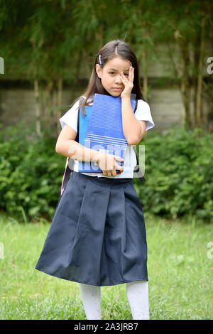 A Child Girl Student And Shyness Stock Photo