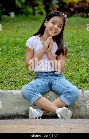 A Praying Petite Filipina Girl Stock Photo