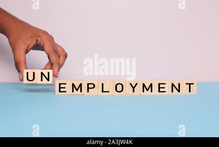Concept of Getting Employment removing words UN from employment word with hands. Stock Photo