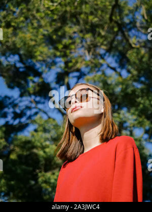 closeup portrait of stylish young girl wearing sunglasses outside Stock Photo