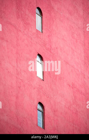 three windows in the red building Stock Photo