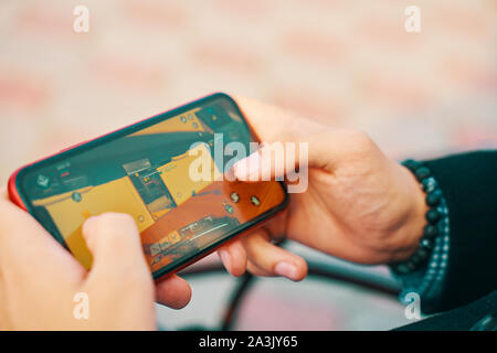 Bishkek, Kyrgyzstan - October 10, 2019: Man playing online game in call of duty mobile on iphone 11 Stock Photo