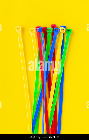 Nylon cable ties on a yellow background Stock Photo