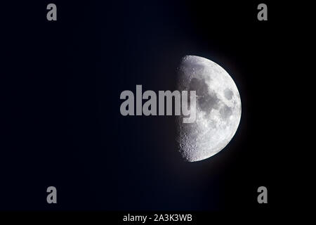 50% Waxing Gibbous Moon; Dark background and Copy space Stock Photo