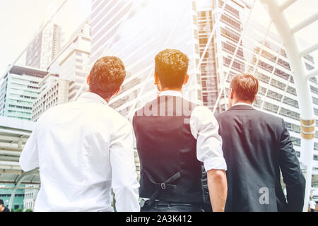 group of business man looking up to the sky and forward to the future of growing profit concept