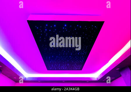 ceiling of a spa center with colored lights and geometric perspective Stock Photo