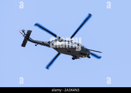 September 23, 2019 Mountain View / CA / USA -  Military helicopter performing search and rescue training exercises around Moffett Federal Airfield in Stock Photo