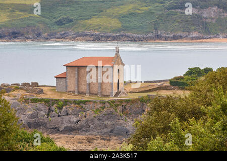 Santa Catalina chapel and Mundaca beach village. Euskadi, Spain Stock Photo