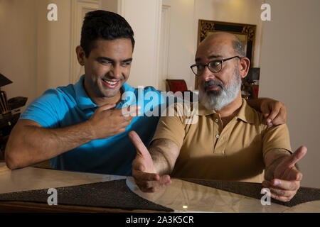 Father and son having fun with each other in the living room. (Family) Stock Photo