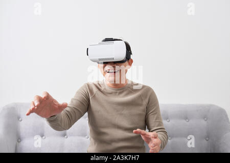 Man wears virtual reality glasses with smartphone inside. vr glasses virtual reality glass 3d cyberspace simulation concept Stock Photo