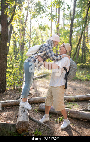 Loving grey-haired wife hugging her handsome man Stock Photo
