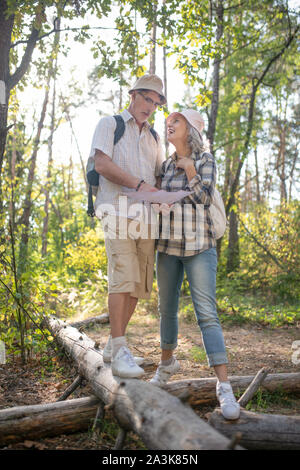 Couple checking the map while walking in huge national park Stock Photo