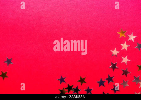 Gold stars on bright red background, abstract image Stock Photo